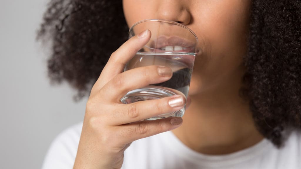 woman drinking a glass of water