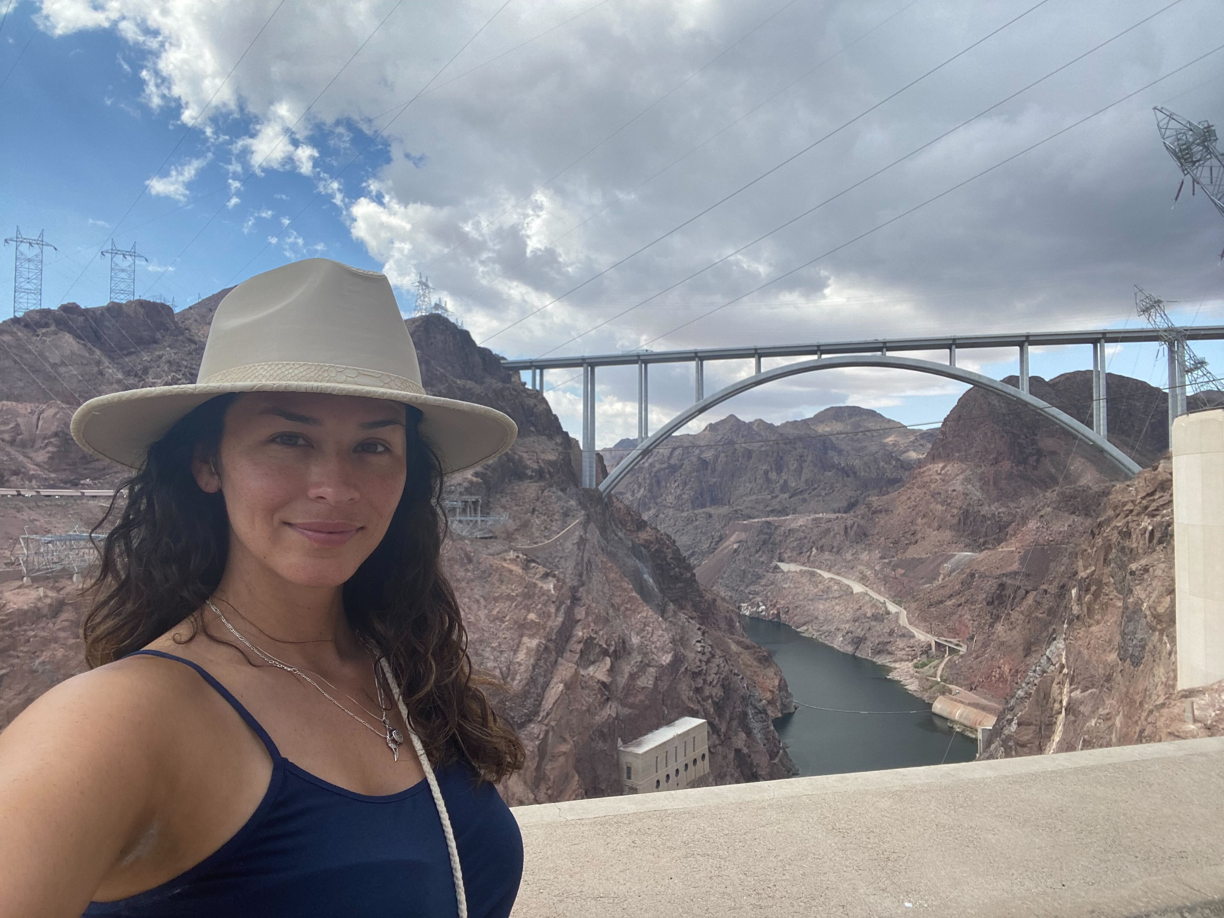 Communications Associate, Briget Arndell standing on top of the Hoover Dam
