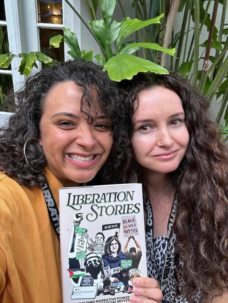 Jessica Jewell and her co-Author, Olivia Blocker holding a copy of Liberation Stories anthology
