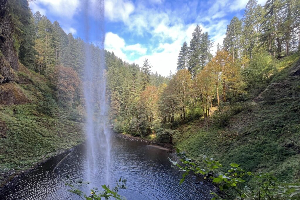 a waterfall from behind on a sunny day