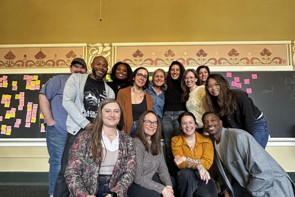 Group photo of a dozen smiling water justice advocates, artists, and communicators.